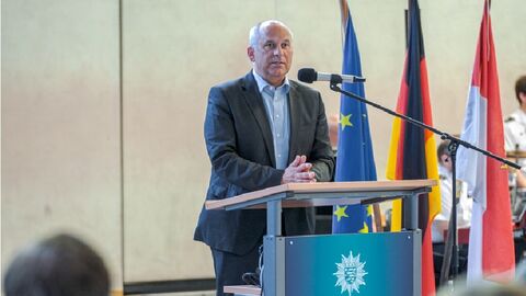 Innenminister Poseck steht hinter einem Rednerpult mit der Aufschrift "Hessisches Polizeiministerium Einsatz"